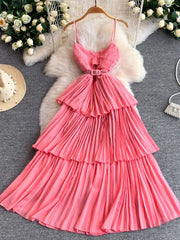 Pink belted pleated midi dress with spaghetti straps and tiered skirt