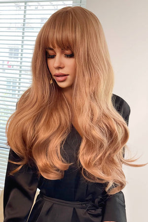 Strawberry blonde wig with baguette bangs and sunset waves, styled casually.