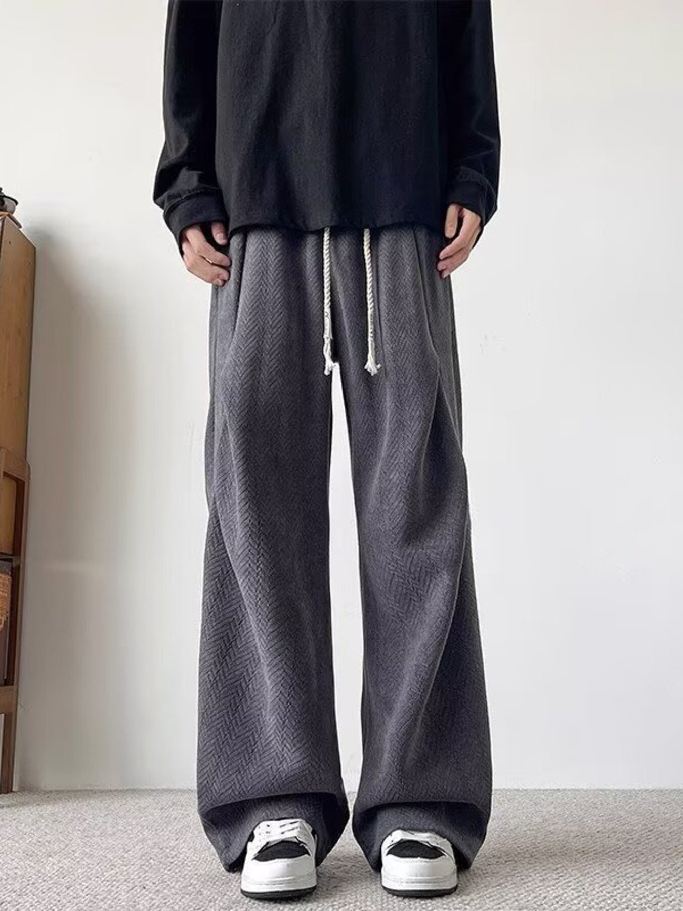 Plus-size dark gray herringbone drawstring sweatpants with wide legs.