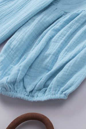 Textured gauze blouse in Pastel Blue with gathered sleeves and elasticized hem.