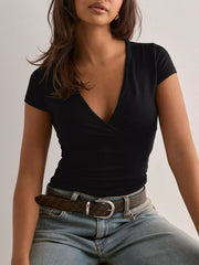 Black crossover ruched fitted t-shirt with short sleeves and a deep V-neck.