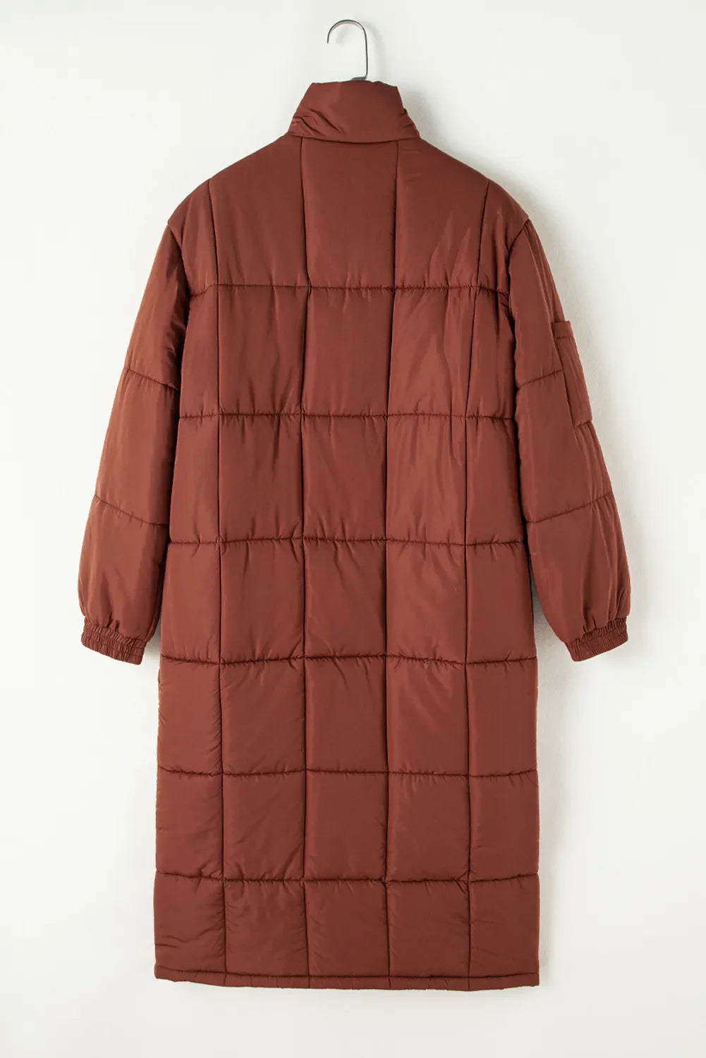 Brown quilted longline puffer coat with patch pockets and elastic cuffs.