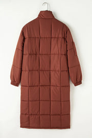 Brown quilted longline puffer coat with patch pockets and elastic cuffs.