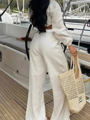 White textured tie-front crop top and wide-leg pants set with balloon sleeves.