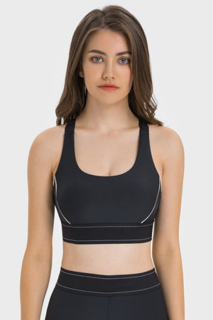 Black performance sports bra with white piping detail and ribbed band