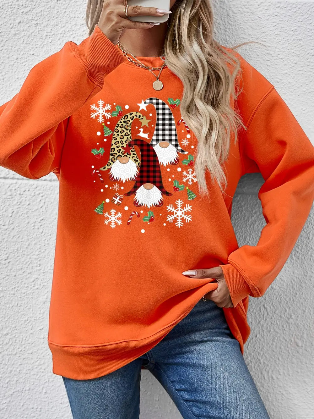 Orange raglan sweatshirt with festive gnome graphic, snowflakes, and candy canes.