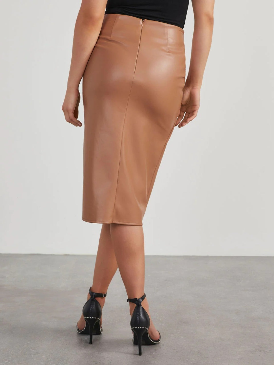 Tan faux leather midi skirt with a draped detail and back zipper.