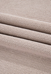 Beige knit sweater fabric detail with textured ribbing