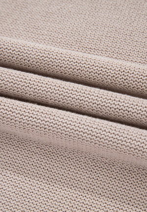 Beige knit sweater fabric detail with textured ribbing