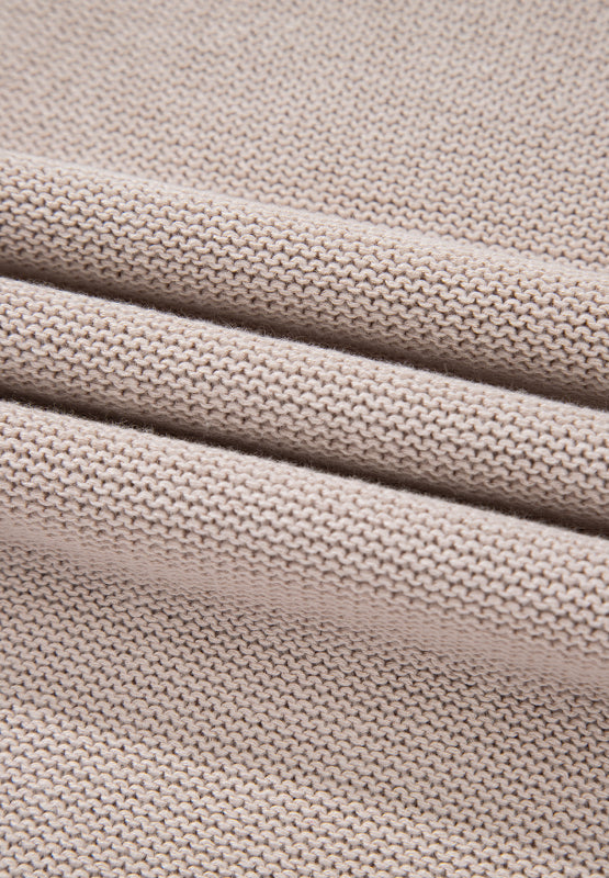 Beige knit sweater fabric detail with textured ribbing