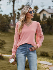 Pink V-neck blouse with Swiss dot sheer puff sleeves and a relaxed fit.