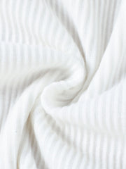 White ribbed knit fabric detail of a baby top and skirt set