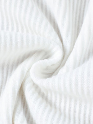 White ribbed knit fabric detail of a baby top and skirt set
