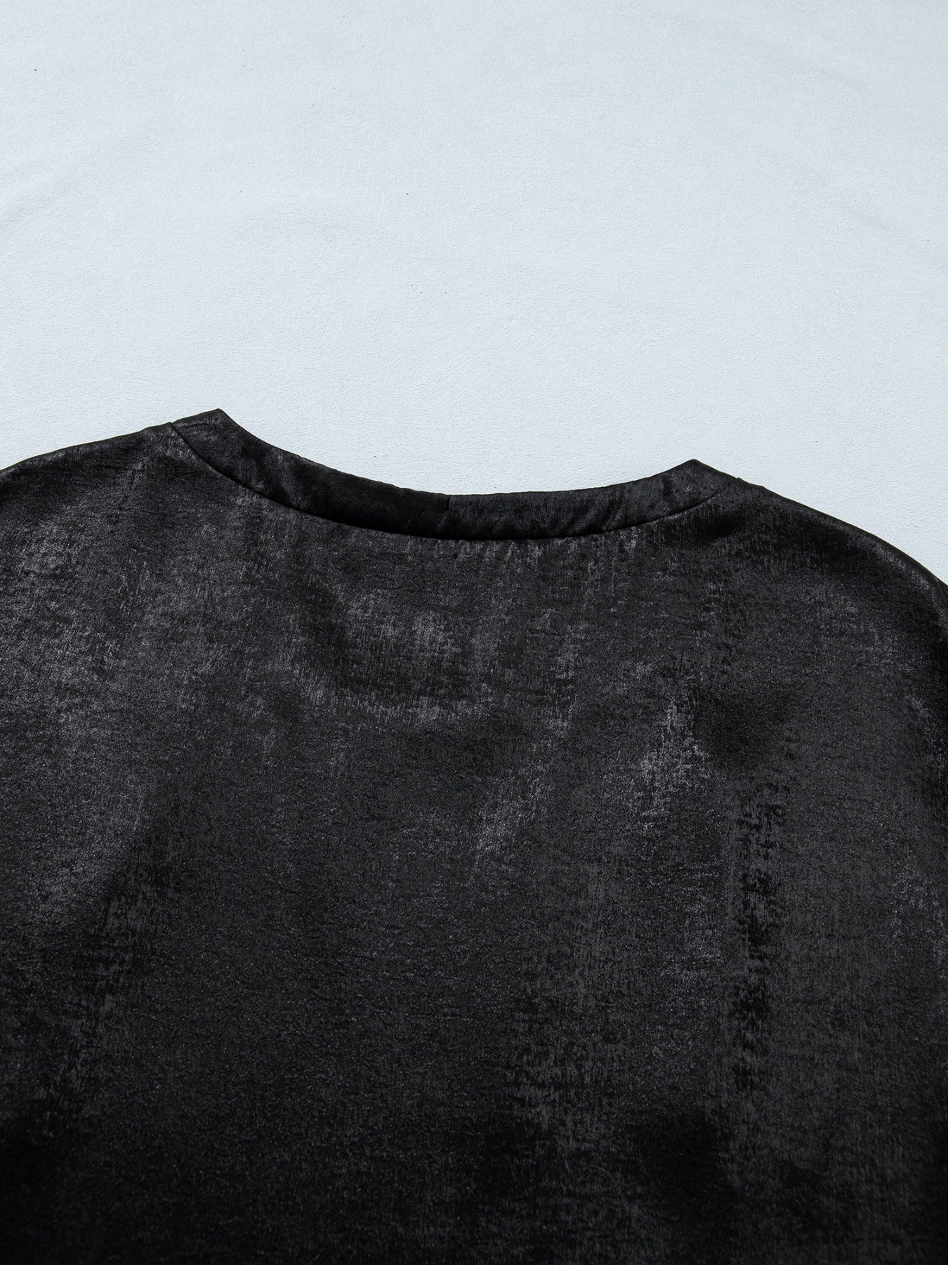 Black metallic tee with round neck and cap sleeves, made of polyester and spandex blend.