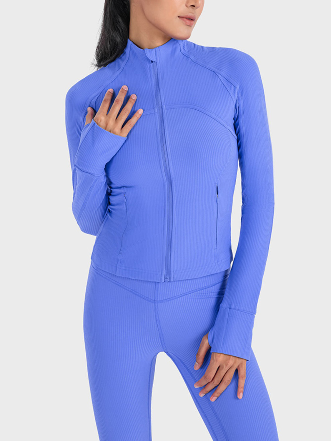 Cobalt blue ribbed performance zip-up jacket with thumbholes and a zippered pocket.