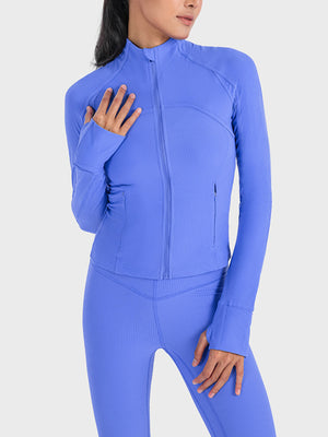 Cobalt blue ribbed performance zip-up jacket with thumbholes and a zippered pocket.