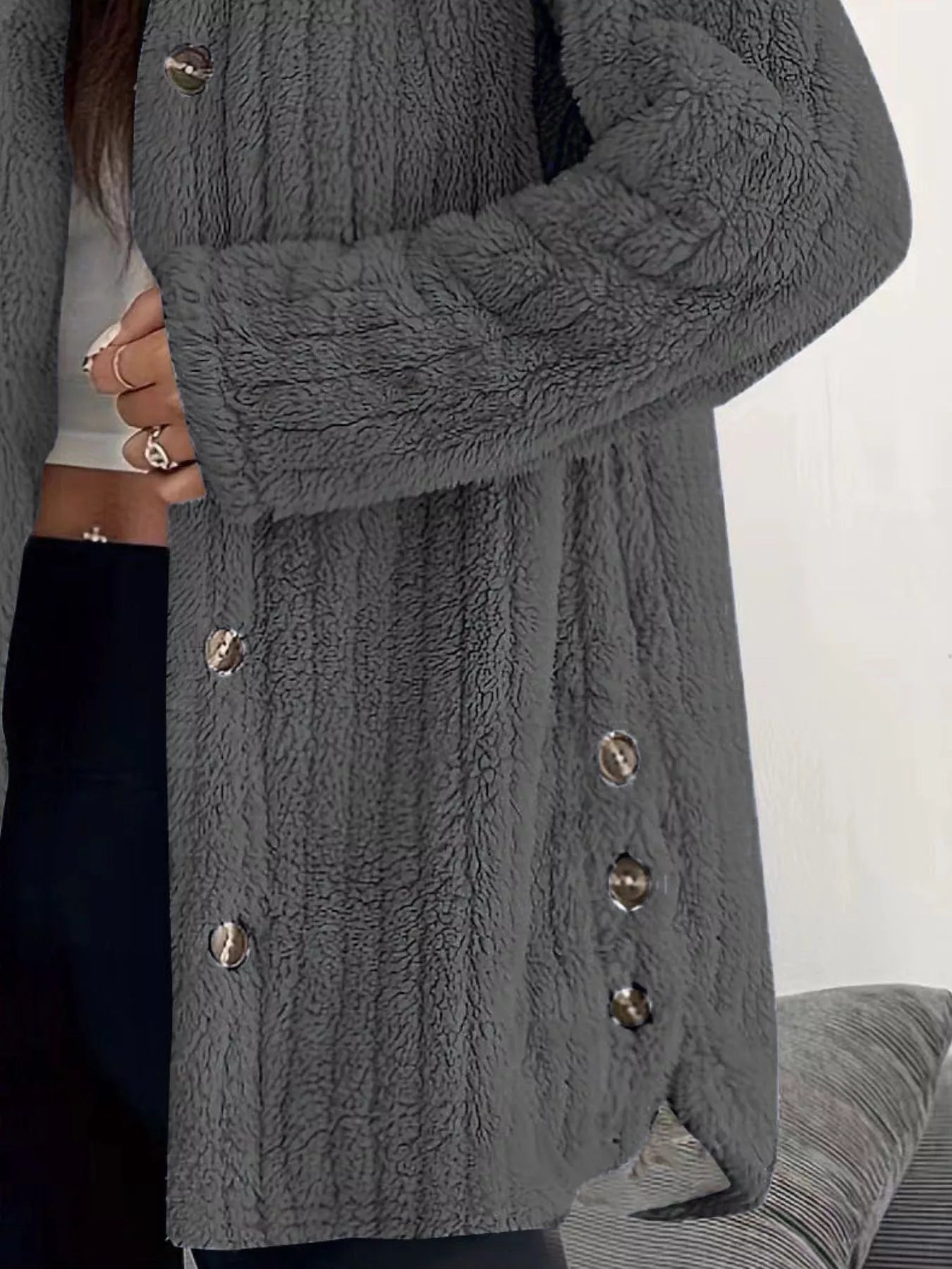 Dark grey button-up fleece jacket with textured fabric and silver buttons.
