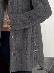 Dark grey button-up fleece jacket with textured fabric and silver buttons.