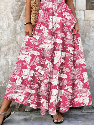 Maxi dress in Strawberry with white leaf print, tiered skirt, and smocked bodice detail.