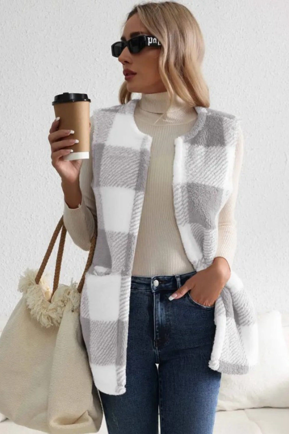 Oversized sherpa gilet in light gray buffalo check with a relaxed fit and pockets.