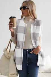 Oversized sherpa gilet in light gray buffalo check with a relaxed fit and pockets.