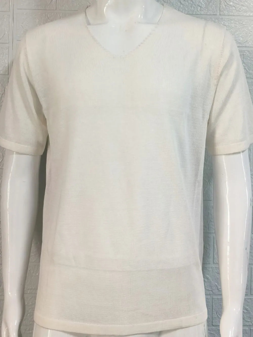 Ivory textured knit tee with subtle V-neck and short sleeves.