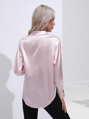 Blush pink satin tie-front blouse with buttoned cuffs and a collared neckline.