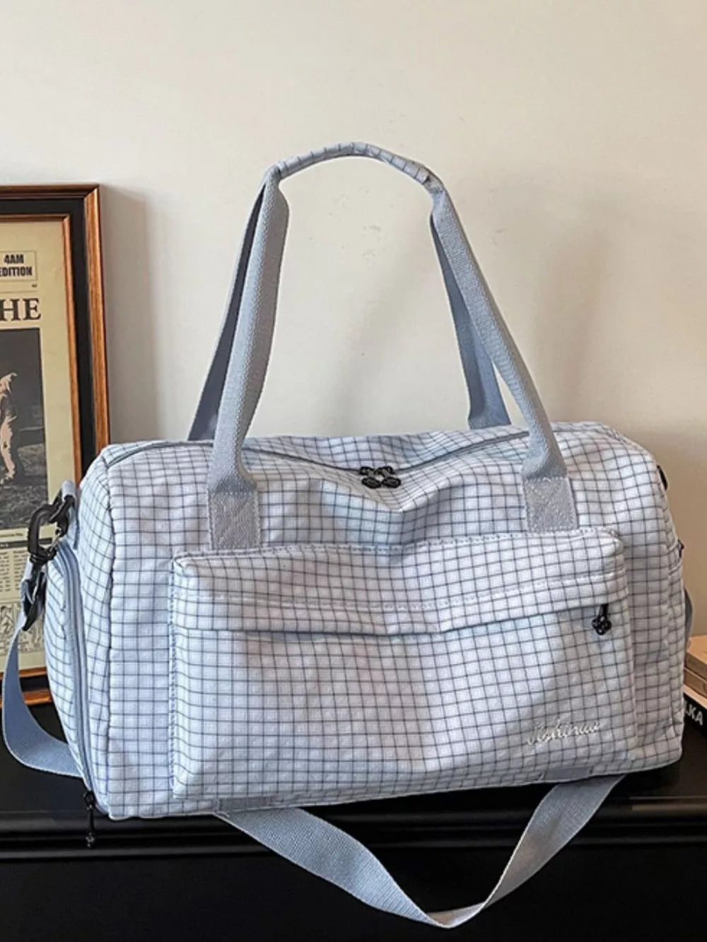 Elegant plaid travel bag with front pocket and versatile straps