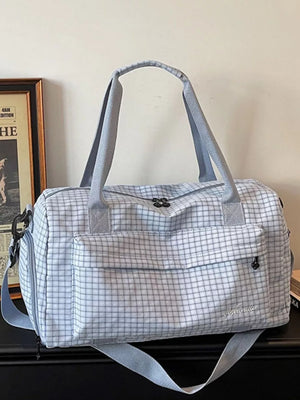 Elegant plaid travel bag with front pocket and versatile straps
