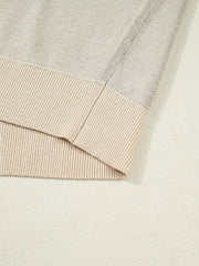 Sleeveless sweater vest in beige acrylic with ribbed trim and knit texture detail.