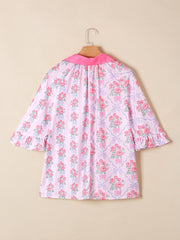 Pink floral and bow print maternity shirt with ruffled sleeves and pink collar.