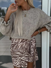 Voluminous sleeve knit sweater in cream with textured sleeves and crewneck.