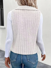 White fleece vest with vertical ribbing and a collared neckline, worn over a white long-sleeve shirt.