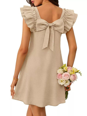 Apricot a-line dress with ruffled cap sleeves and a large back bow.