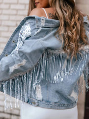 Denim trucker jacket with sequin fringe and distressed details.