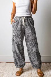 Leopard print wide-leg pants with grey star accents and a drawstring waist.