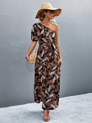 Black tropical print one-shoulder maxi dress with balloon sleeves and tie waist.