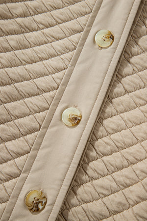 Beige diamond quilted oversized button-up jacket with marbled buttons.