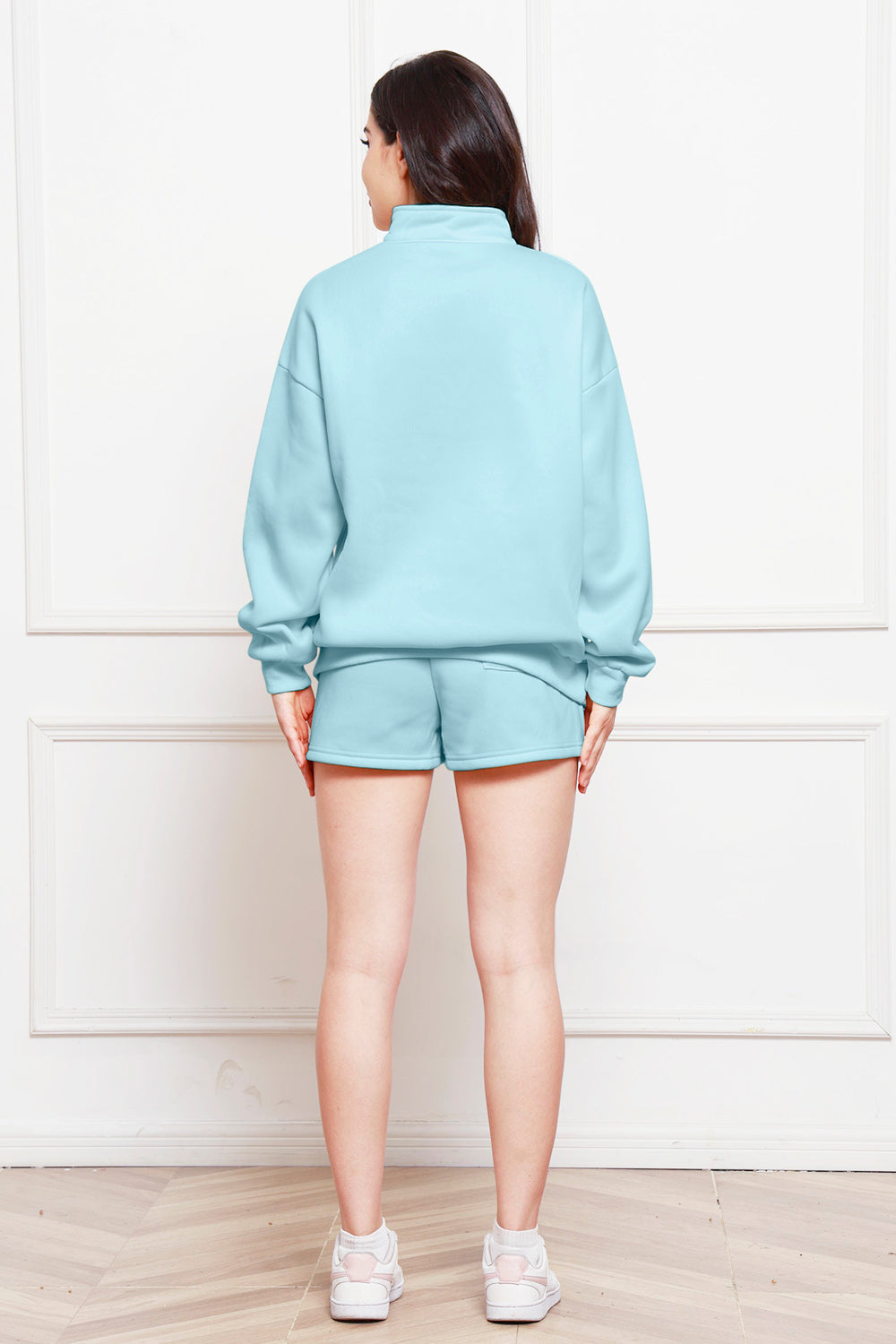 Light Blue quarter-zip loungewear set with shorts and a mock neck sweatshirt.