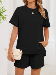Black relaxed two-piece set with crew neck t-shirt and shorts, featuring pockets.