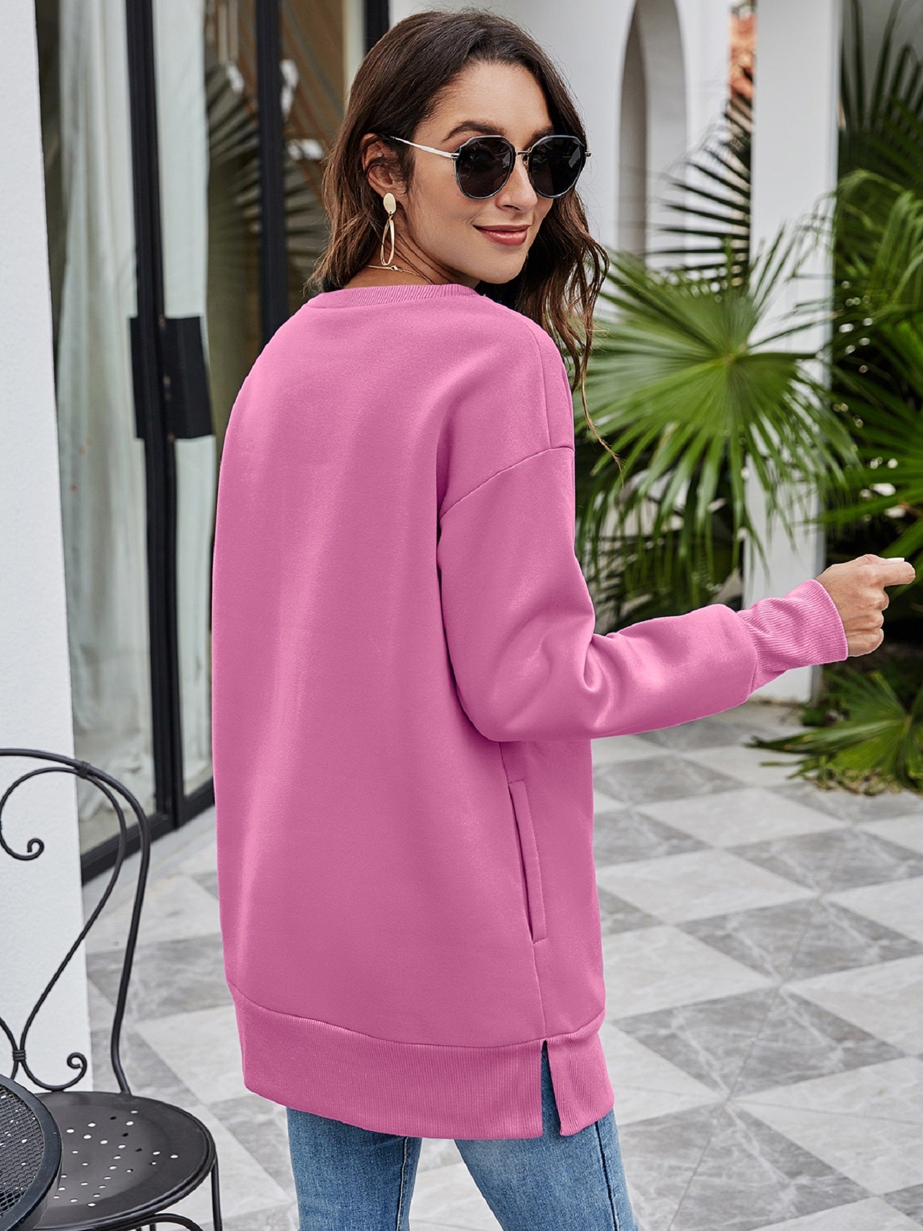 Dusty Pink tunic sweatshirt with crew neck, long sleeves, side pockets, and side slits.