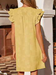 Apricot floral embossed mini dress with ruffled sleeves and button detail.