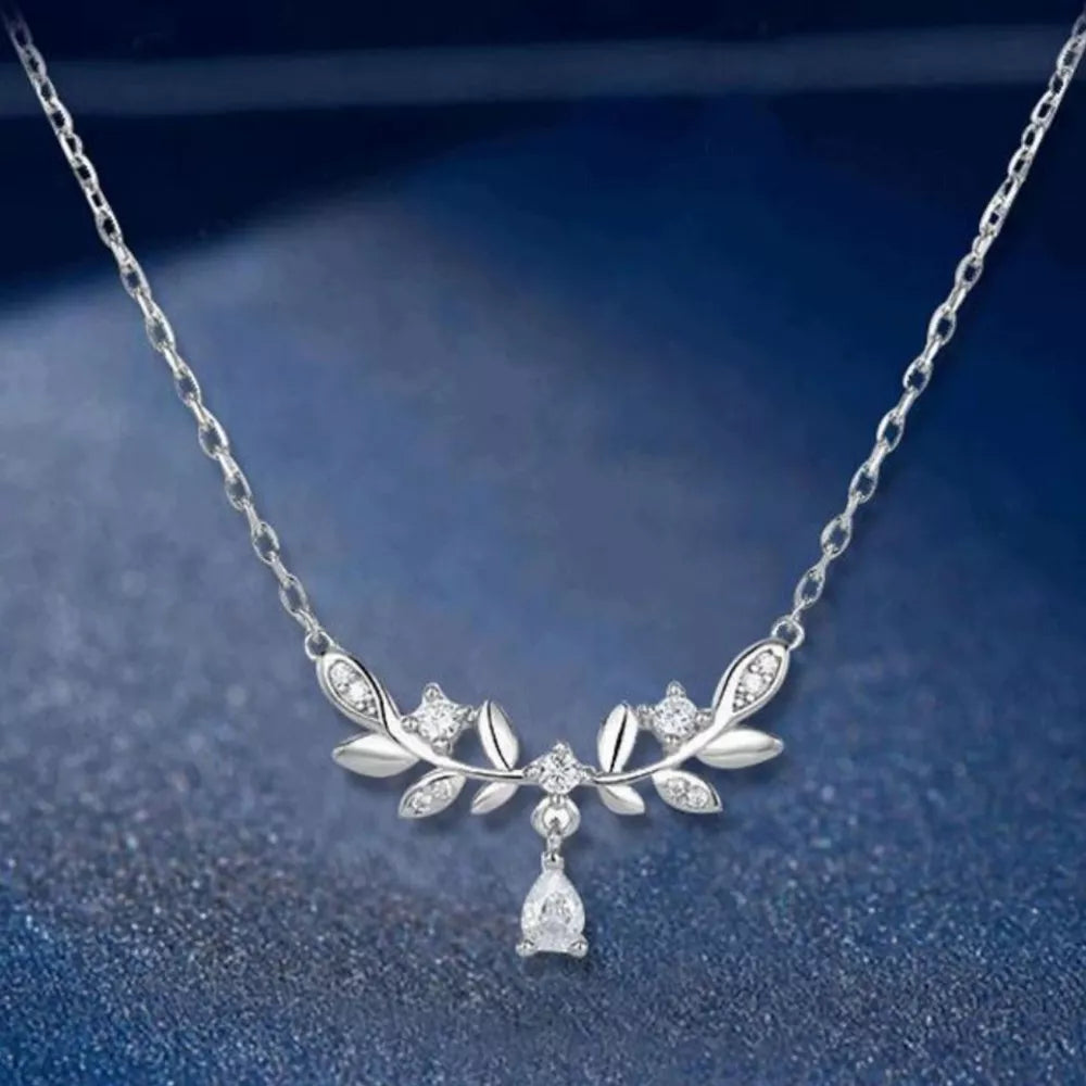 Silver zircon flower pendant necklace with a pear-shaped drop, delicate chain.