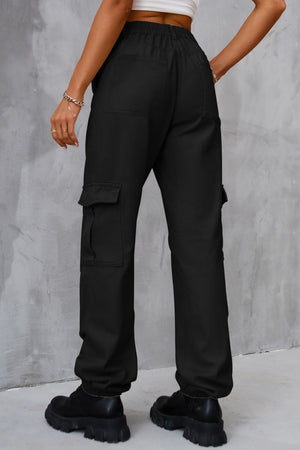 Black cargo trousers with elasticated cuffs and multiple pockets.