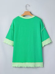 Bright green ribbed t-shirt with contrast stitching and lettuce hem cuffs and hem.
