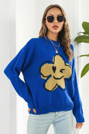 Royal blue acrylic sweater with yellow-green smiley flower intarsia knit pattern.