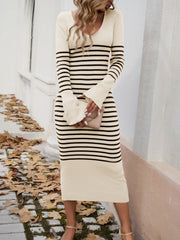 Striped knit midi dress in ivory with black stripes, V-neck, long flared sleeves, and bodycon fit.