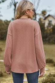 Dusty Pink cable knit V-neck pullover sweater with textured detail and long sleeves.