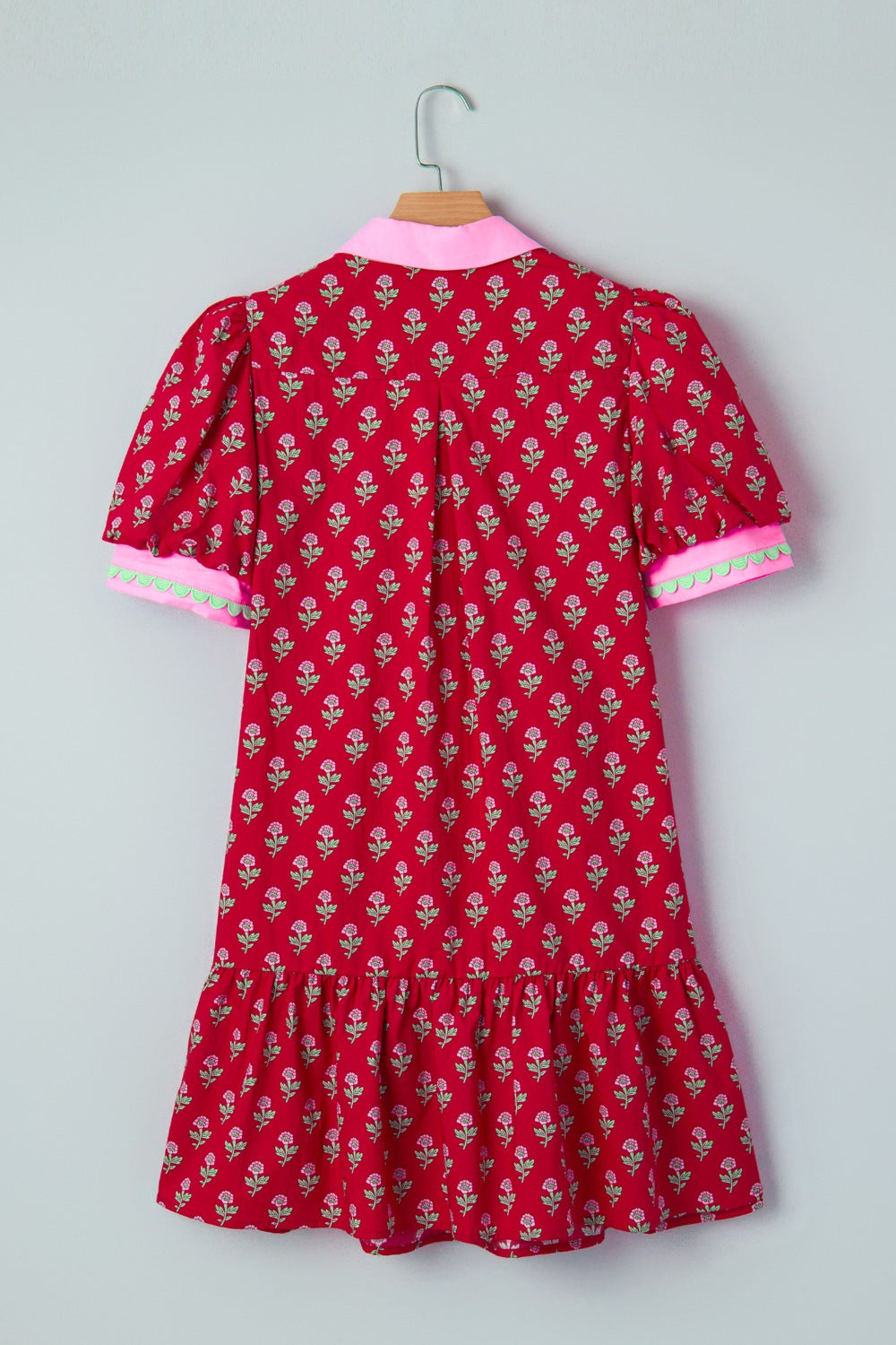 Red floral mini dress with puff sleeves, pink collar, and scalloped trim cuffs.