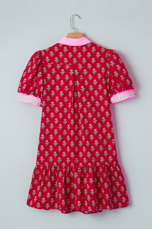 Red floral mini dress with puff sleeves, pink collar, and scalloped trim cuffs.